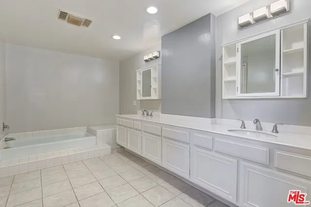 a bathroom with a sink a toilet and bathtub