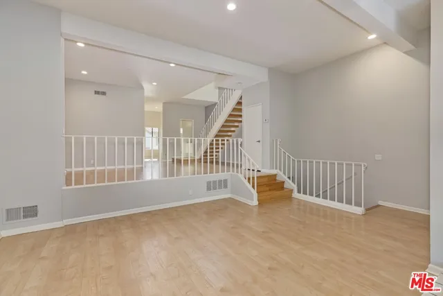 a view of an empty room with glass door
