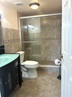 a bathroom with a toilet a sink and shower