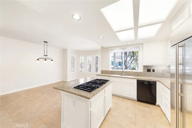 a kitchen with a refrigerator and a stove top oven