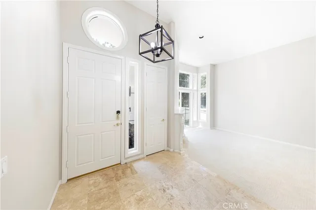 a view of a room with wooden floor and white walls
