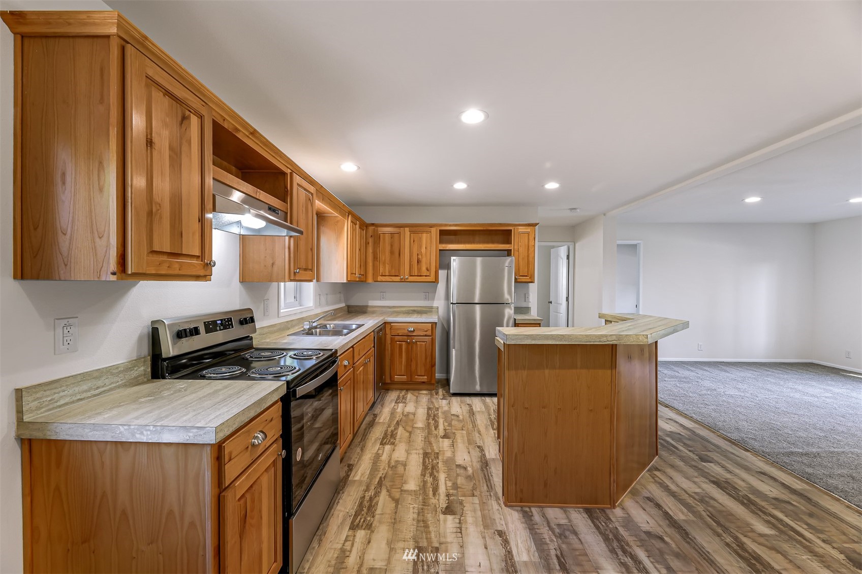 3616 North Red River Road Ferndale, WA 98248 - Photo 11 of 28 a kitchen with stainless steel appliances granite countertop a stove a sink and a refrigerator