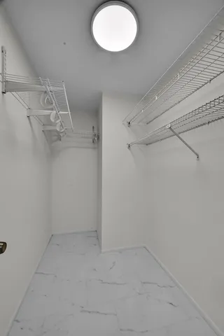 a bathroom with a shower sink vanity and toilet