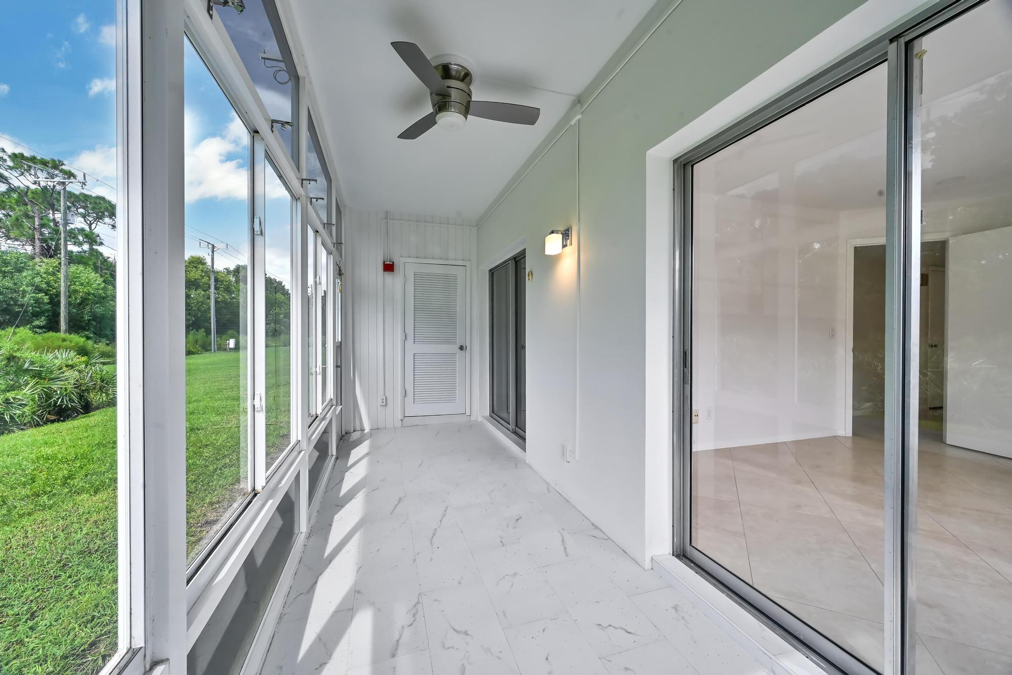 2 Lake Vista Trail, Unit 107 Port St. Lucie, FL 34952 - Photo 18 of 19 a view of a hallway with a glass door and shower