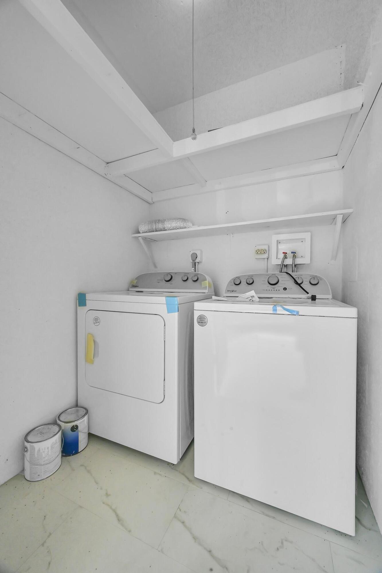 2 Lake Vista Trail, Unit 107 Port St. Lucie, FL 34952 - Photo 19 of 19 a utility room with dryer and washer