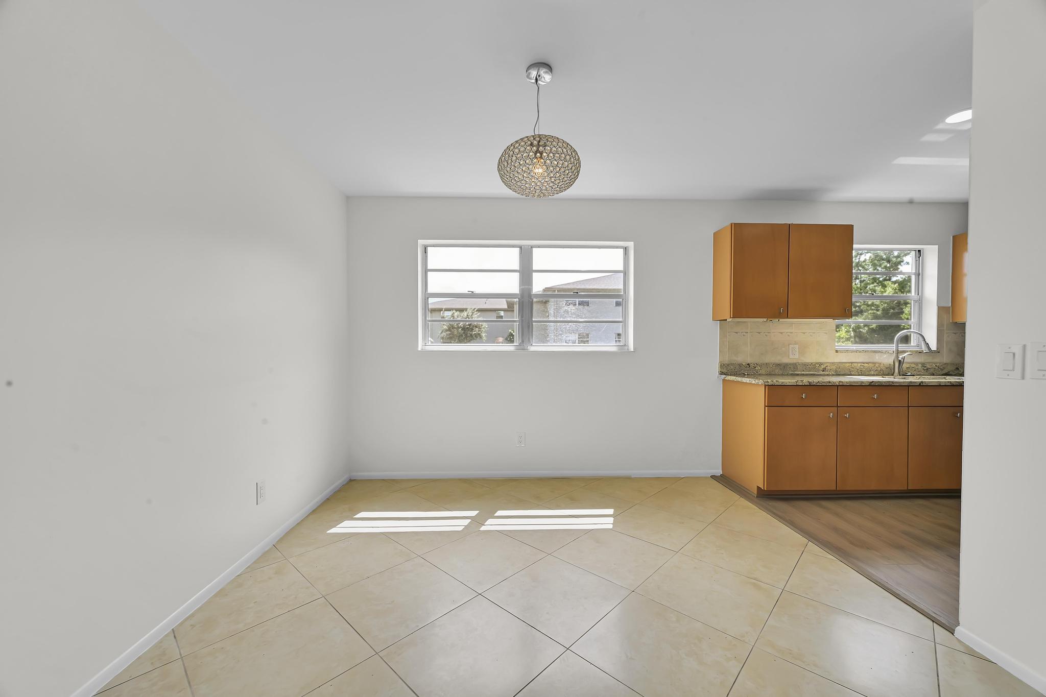 2 Lake Vista Trail, Unit 107 Port St. Lucie, FL 34952 - Photo 5 of 19 a view of a room with wooden floor and window