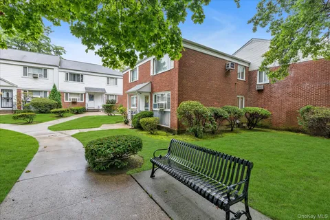 a view of a chair and table in the front of the house
