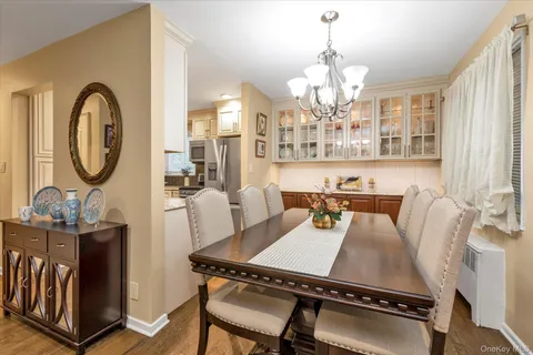 a living room with furniture a chandelier and a large mirror