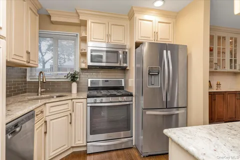 a kitchen with a refrigerator stove and sink