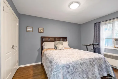 a bed sitting in a bedroom next to a window