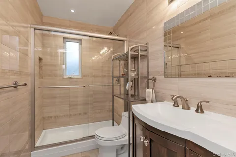 a bathroom with a sink toilet and shower
