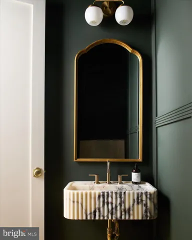 a bathroom with a sink a mirror and shower