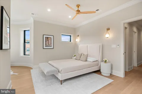 a spacious bedroom with a large bed and a chandelier