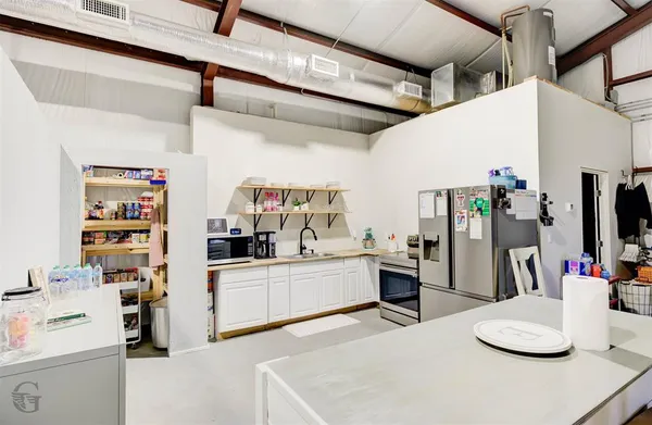 a kitchen with table and chairs