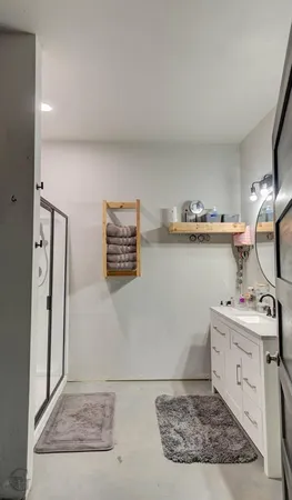 a room with a sink cabinets and a mirror