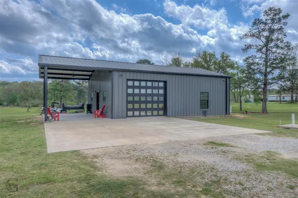 a view of a house with a outdoor space and a yard