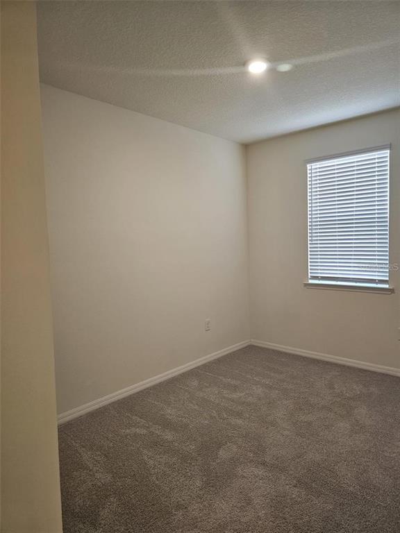4389 Small Creek Road Kissimmee, FL 34744 - Photo 11 of 17 an empty room with a window