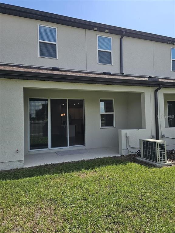 4389 Small Creek Road Kissimmee, FL 34744 - Photo 16 of 17 a view of a house with a yard and sitting space