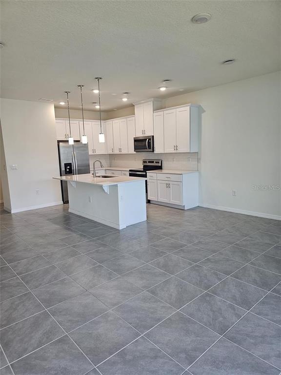 4389 Small Creek Road Kissimmee, FL 34744 - Photo 4 of 17 a large kitchen with cabinets