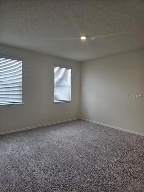 4389 Small Creek Road Kissimmee, FL 34744 - Photo 6 of 17 an empty room with a window