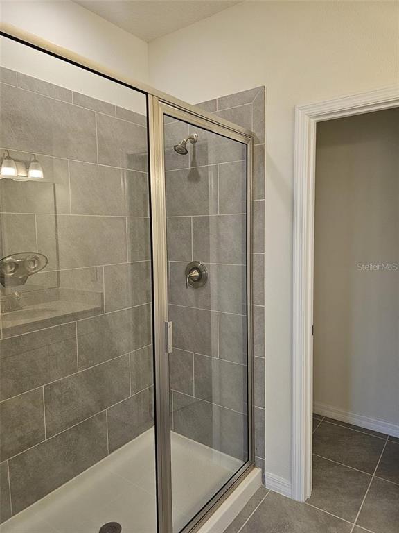 4389 Small Creek Road Kissimmee, FL 34744 - Photo 8 of 17 a bathroom with a shower and a sink