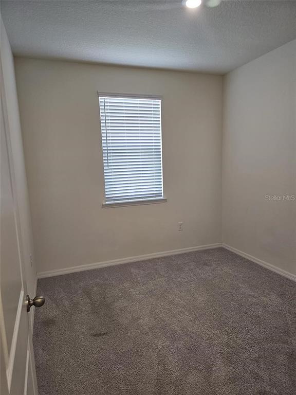 4389 Small Creek Road Kissimmee, FL 34744 - Photo 10 of 17 an empty room with a window
