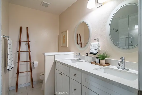 a bathroom with 2 sink and a mirror