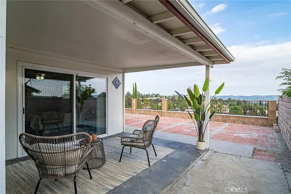 a porch with outdoor seating