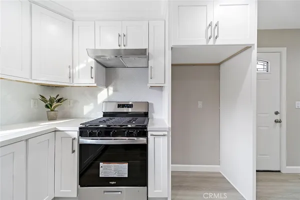 a kitchen with stainless steel appliances granite countertop a stove and a refrigerator