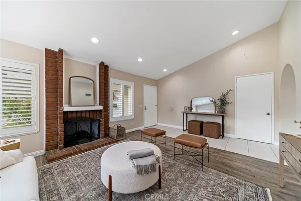 a living room with furniture fireplace and window