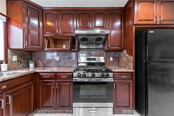 a kitchen with granite countertop stainless steel appliances and cabinets