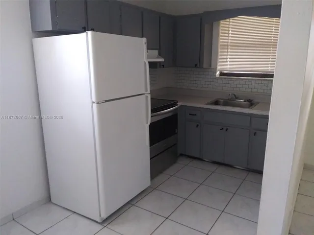 a white refrigerator freezer sitting inside of a kitchen