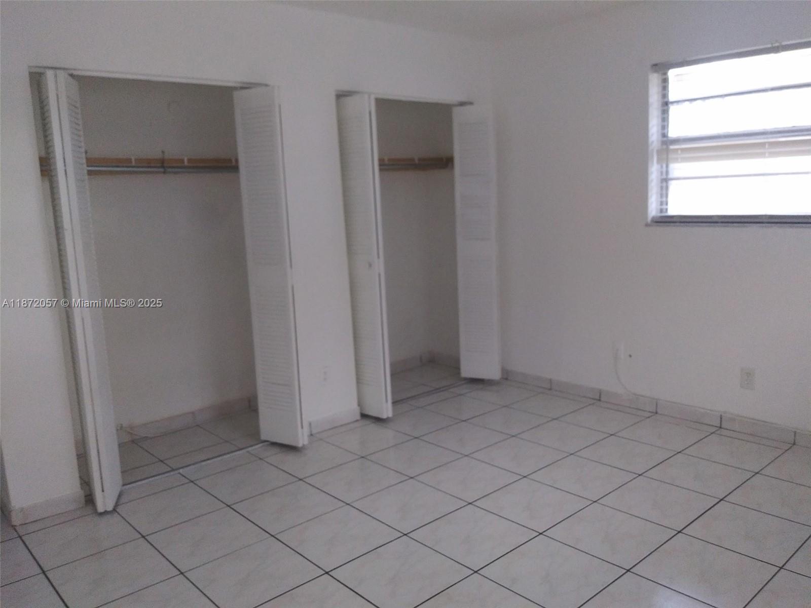6147 Arthur Street, Unit 1 Hollywood, FL 33024 - Photo 4 of 4 an empty room with white door