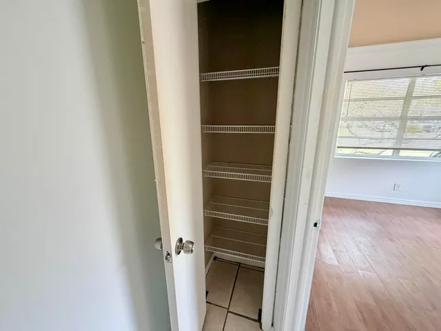 a view of closet area with empty room