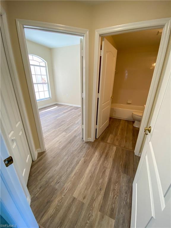 1993 Crestview Way, Unit 129 Naples, FL 34119 - Photo 18 of 26 wooden floor in a gallery