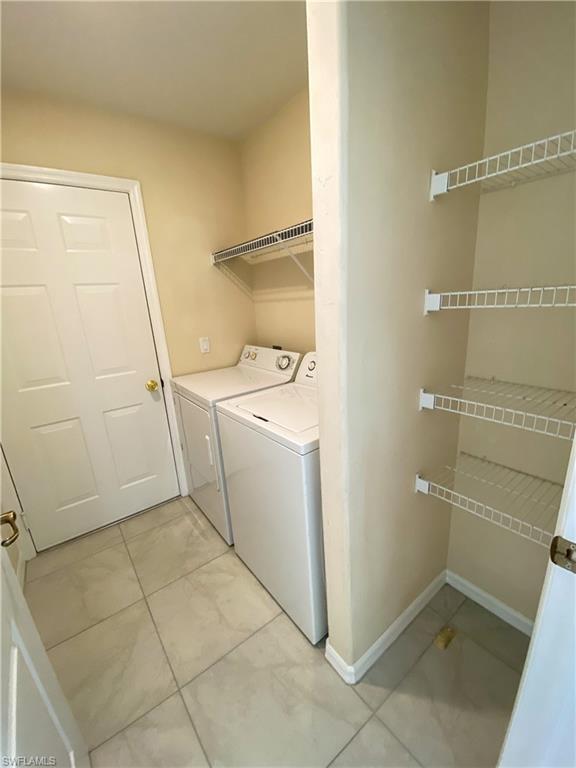 1993 Crestview Way, Unit 129 Naples, FL 34119 - Photo 21 of 26 a utility room with dryer and washer
