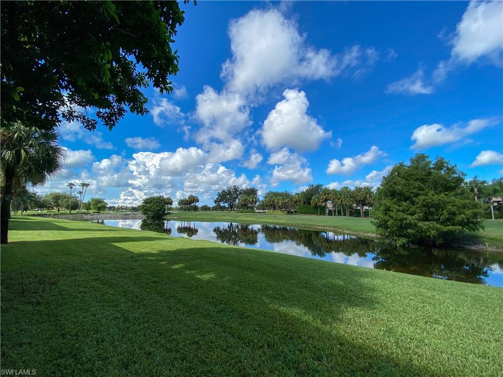 1993 Crestview Way, Unit 129 Naples, FL 34119 - Photo 25 of 26 a view of a lake in front of house with yard and outdoor seating