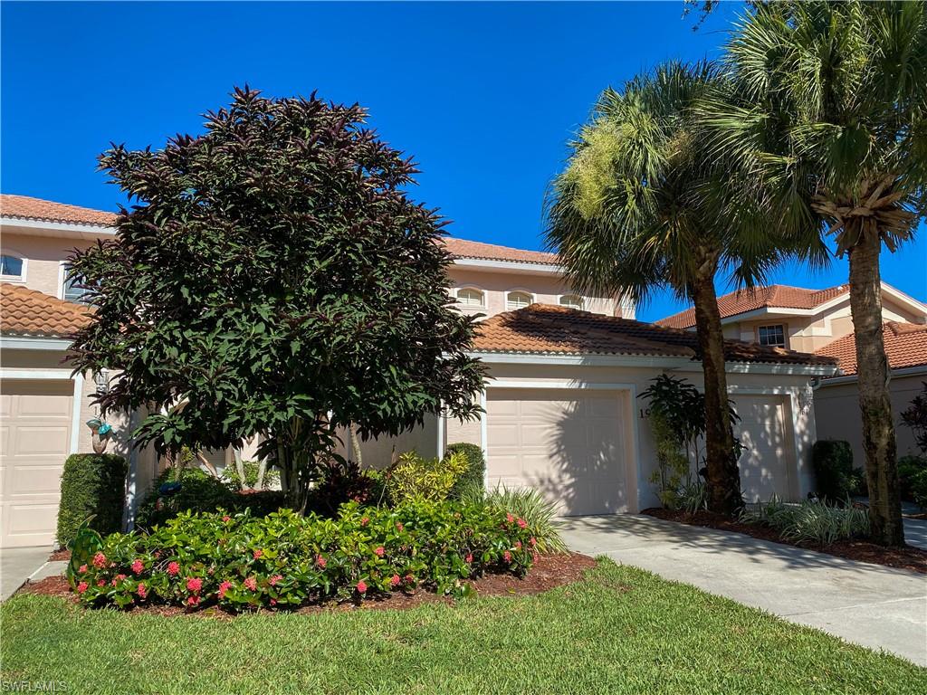 1993 Crestview Way, Unit 129 Naples, FL 34119 - Photo 4 of 26 front view of a house with a garden