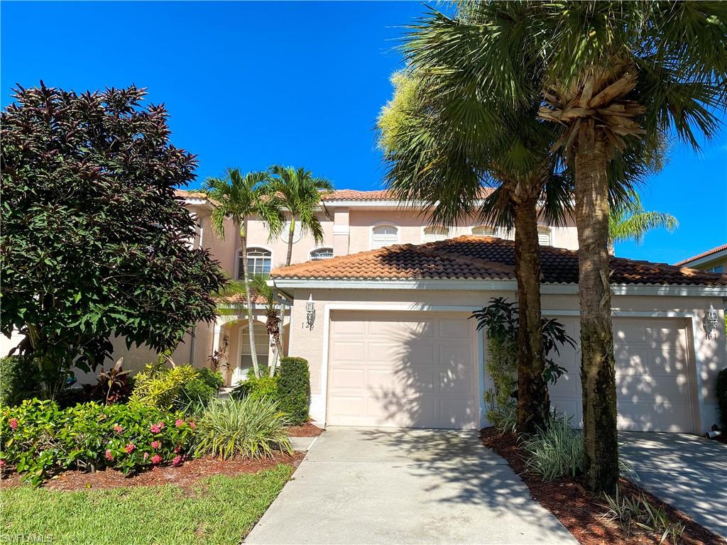 1993 Crestview Way, Unit 129 Naples, FL 34119 - Photo 5 of 26 a front view of a house with a garden