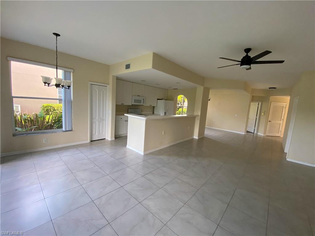 1993 Crestview Way, Unit 129 Naples, FL 34119 - Photo 9 of 26 a view of a kitchen with furniture and a ceiling fan