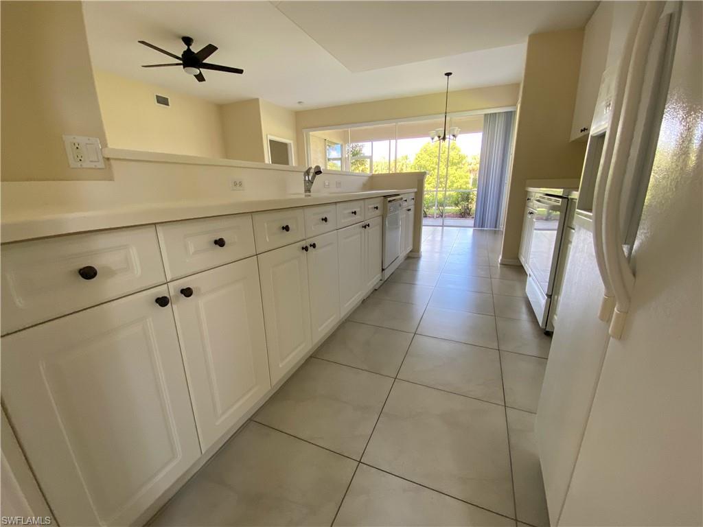 1993 Crestview Way, Unit 129 Naples, FL 34119 - Photo 10 of 26 a bathroom with a sink a mirror and a shower