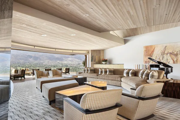 a living room with furniture and a chandelier