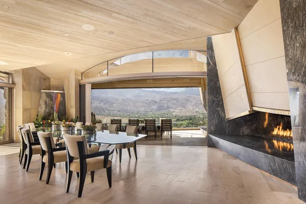 a dining room with furniture and a floor to ceiling window