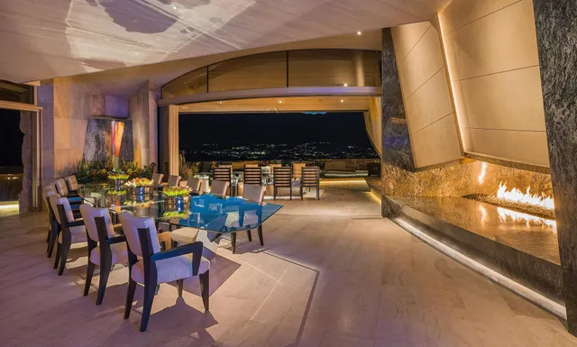 a large living room with stainless steel appliances kitchen island granite countertop a large kitchen counter top and couches