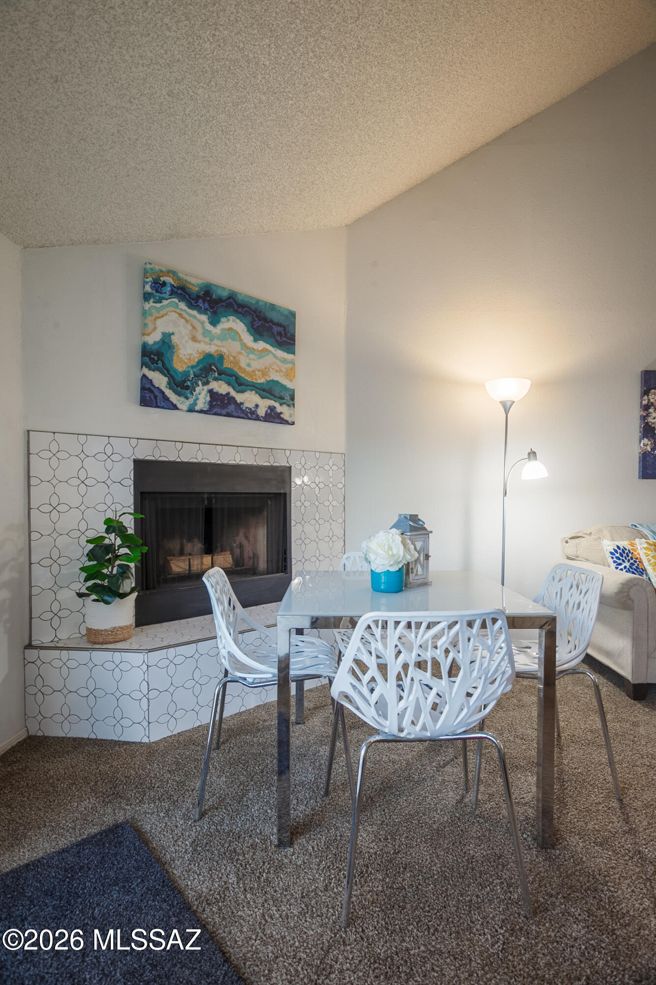 1200 East River Road, Unit B27 Tucson, AZ 85718 - Photo 13 of 40 a living room with furniture and a fireplace