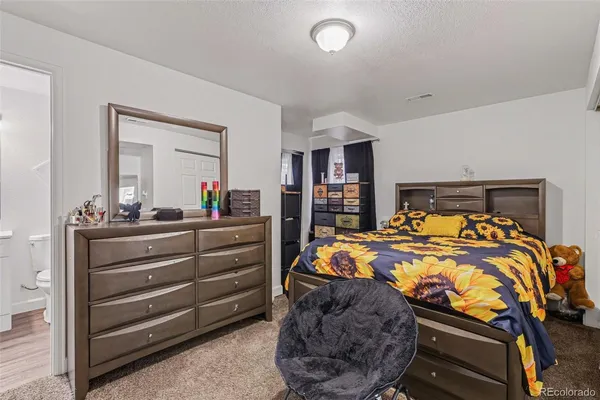 a bed room with a bed and a mirror