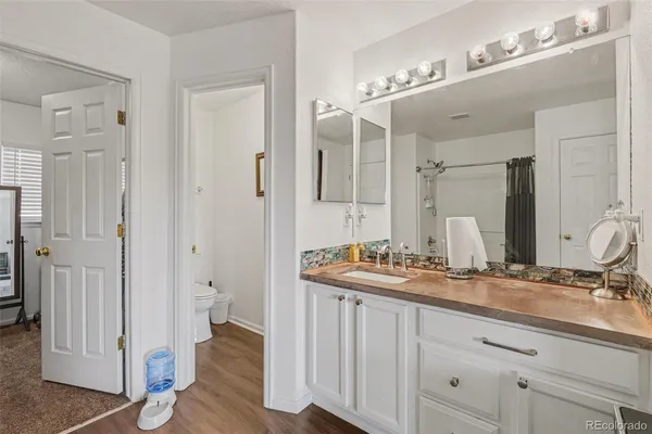 a bathroom with a double vanity sink and mirror