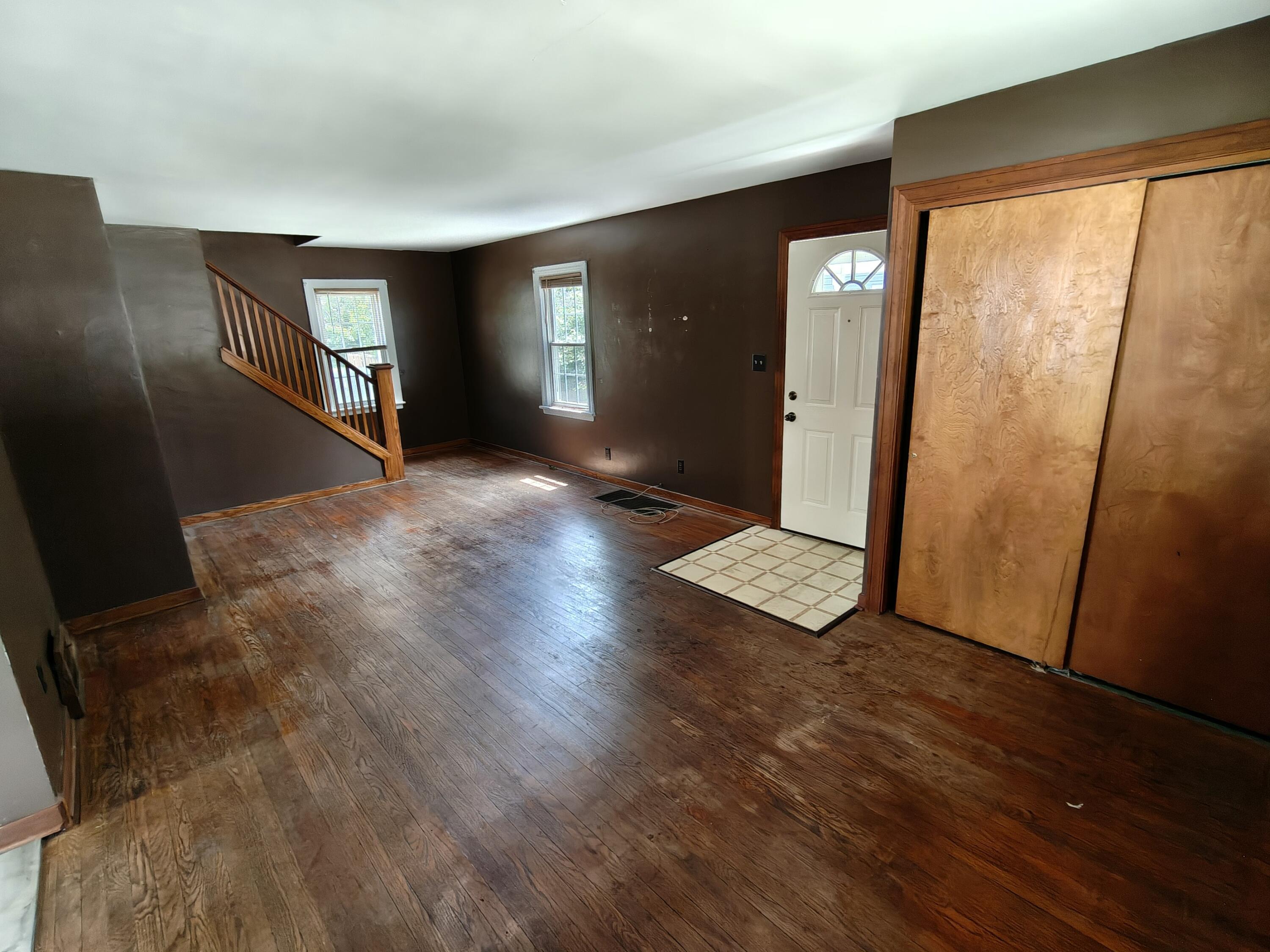 245 North Indiana Street Griffith, IN 46319 - Photo 5 of 30 an empty room with wooden floor and windows
