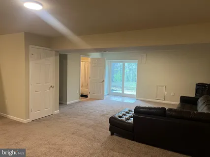 a living room with furniture fireplace and window