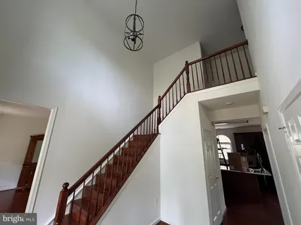a view of staircase with railing and white walls